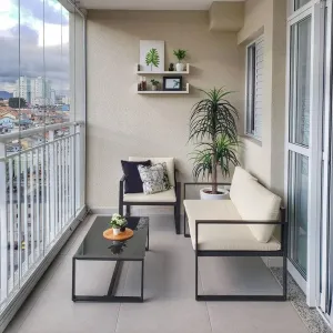 Balcony Design With Sleek Black Metal Furniture, Neutral Tones, And Greenery For A Relaxing Outdoor Retreat